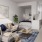 Model studio apartment at our Washington DC apartment building, featuring wood grain floor paneling and a bed.