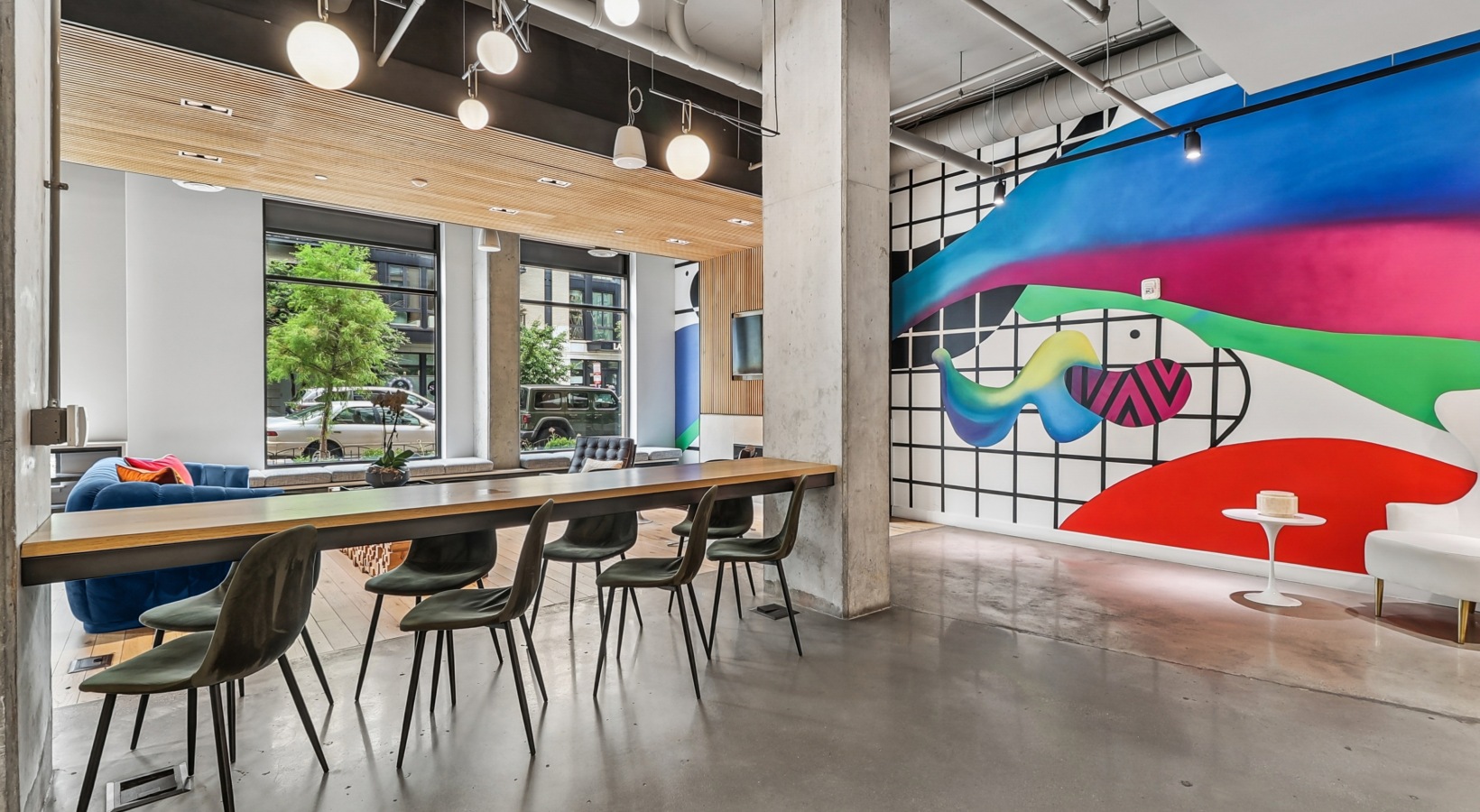 Modern resident lobby at Collection 14 featuring vibrant colorful accents, artful design elements, and contemporary seating.